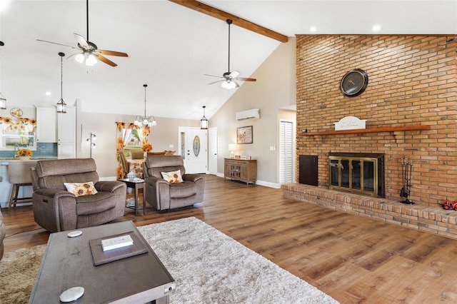 living room featuring a wall mounted air conditioner, dark hardwood / wood-style flooring, a brick fireplace, beam ceiling, and high vaulted ceiling