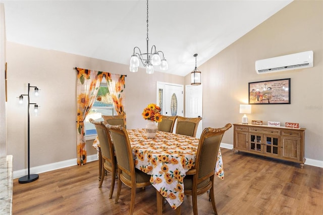 dining space featuring a chandelier, wood-type flooring, an AC wall unit, and vaulted ceiling