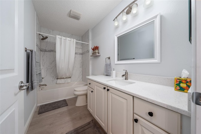 full bathroom with toilet, vanity, shower / bath combo, wood-type flooring, and a textured ceiling