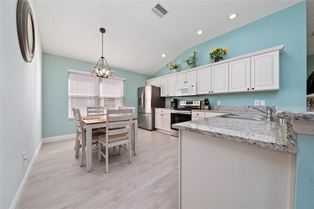 kitchen with pendant lighting, sink, an inviting chandelier, stainless steel appliances, and white cabinets