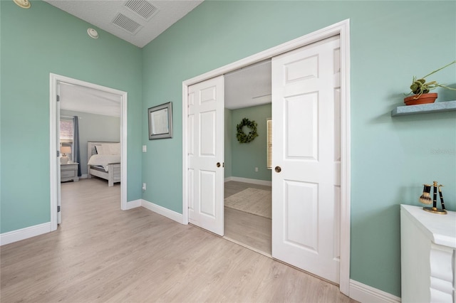 bedroom featuring light hardwood / wood-style floors and a closet