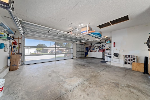 garage with a workshop area and a garage door opener