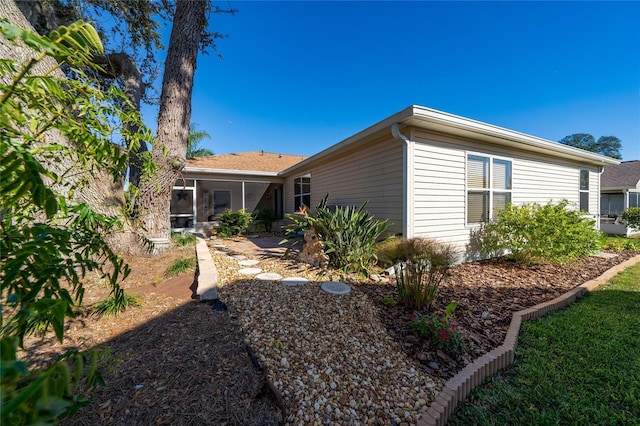 rear view of property with a sunroom