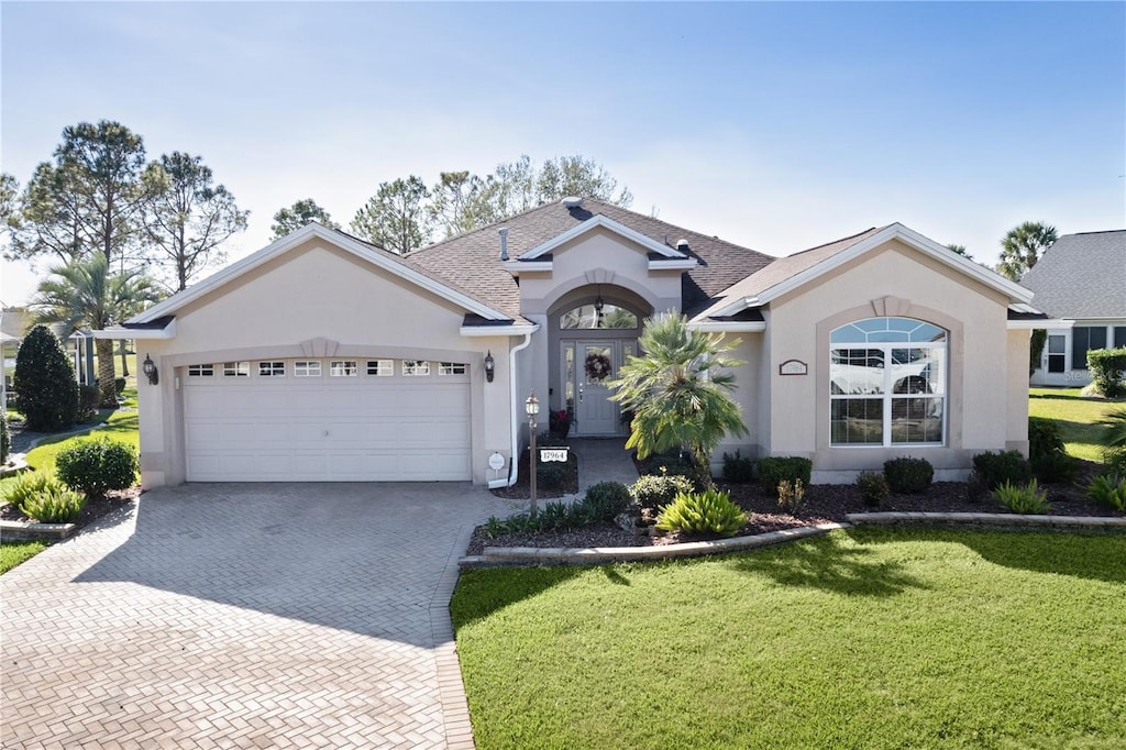 ranch-style house with a front lawn and a garage