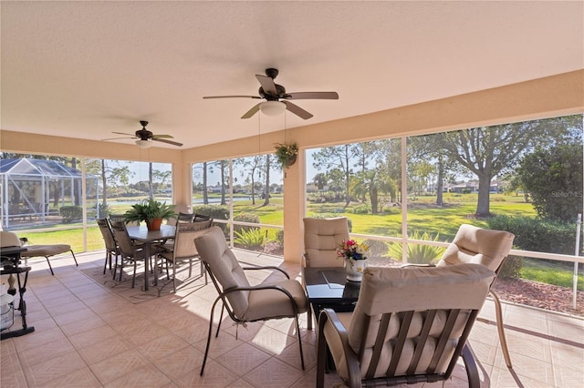 sunroom with ceiling fan