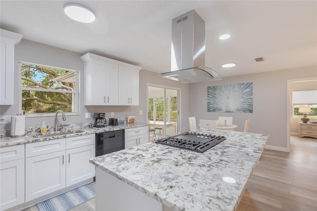 kitchen with island exhaust hood, stainless steel gas cooktop, sink, dishwasher, and white cabinetry