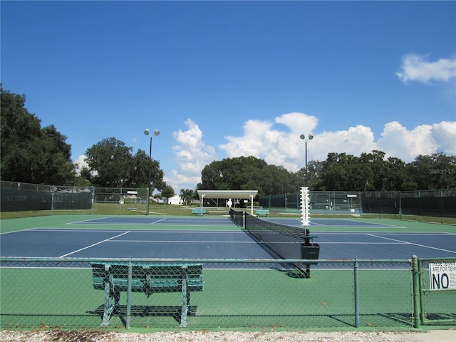 view of tennis court featuring basketball court