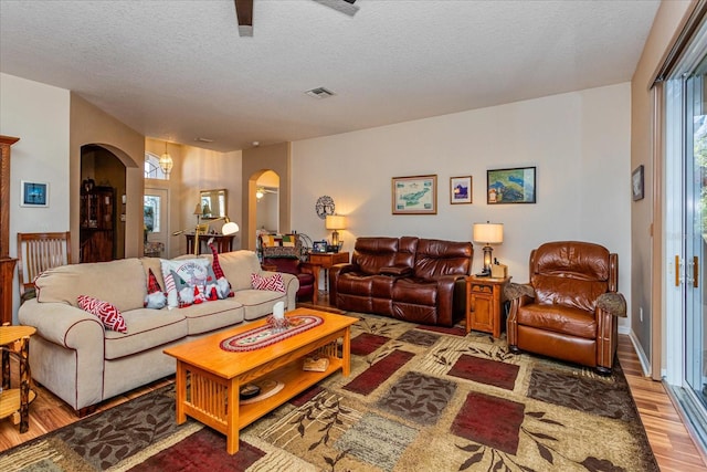 living room with hardwood / wood-style flooring and a textured ceiling