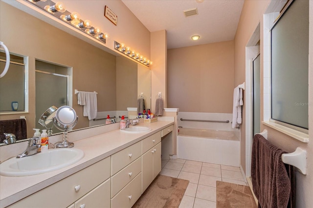 bathroom featuring tile patterned flooring, vanity, and shower with separate bathtub