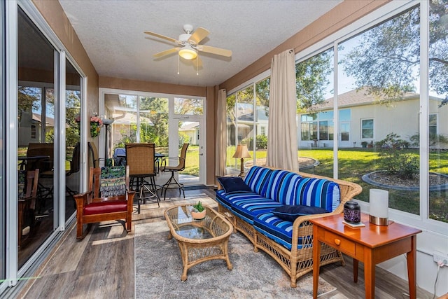 sunroom / solarium featuring ceiling fan