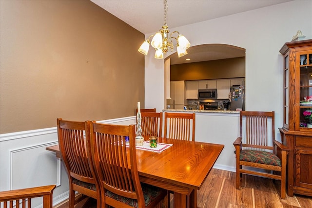 dining space featuring a chandelier and hardwood / wood-style floors