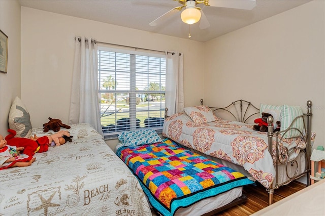 bedroom with ceiling fan and hardwood / wood-style floors