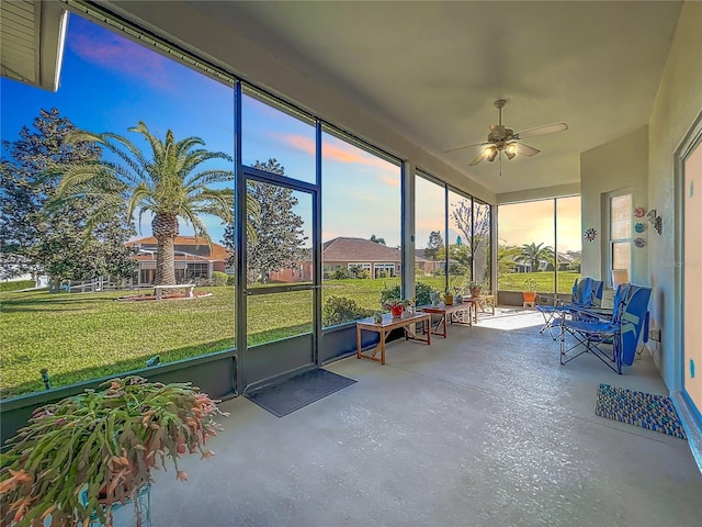 sunroom featuring ceiling fan