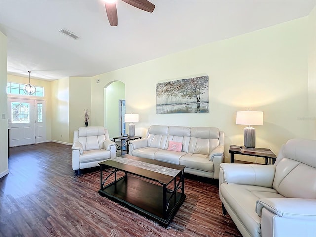 living room with ceiling fan and dark hardwood / wood-style floors