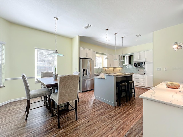 dining space with plenty of natural light, dark wood-type flooring, and sink