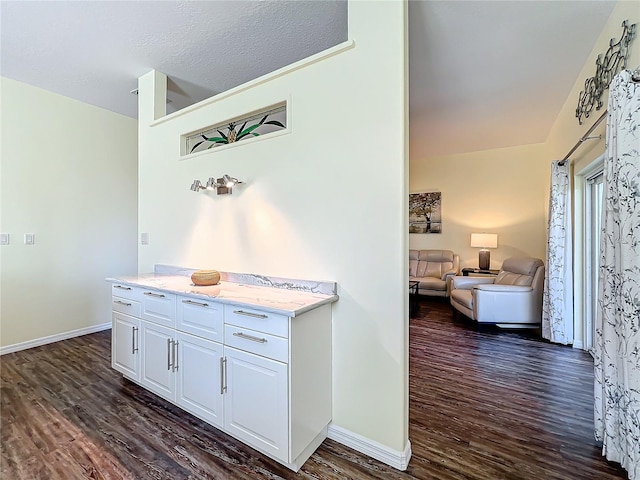 interior space featuring a textured ceiling and dark hardwood / wood-style floors