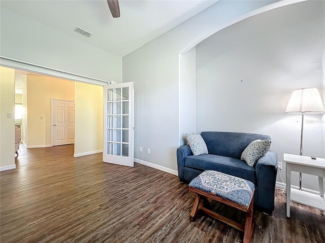 living area featuring french doors, dark hardwood / wood-style floors, and ceiling fan