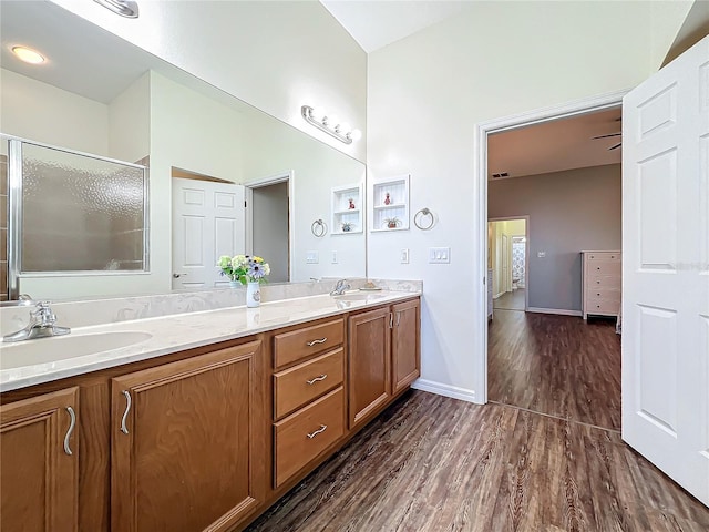 bathroom featuring vanity, an enclosed shower, and wood-type flooring