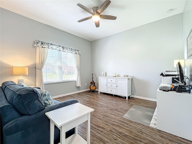 living room featuring ceiling fan and dark hardwood / wood-style flooring