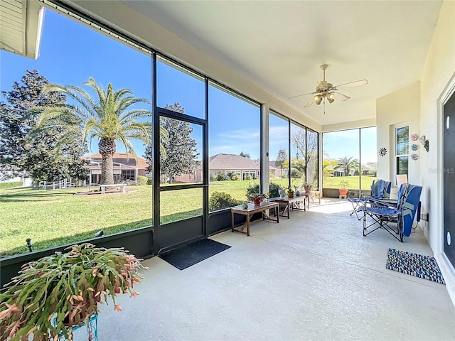 sunroom featuring ceiling fan