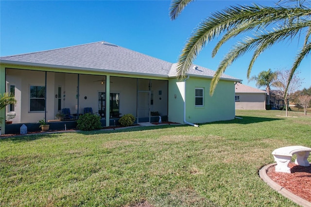 rear view of house featuring a yard