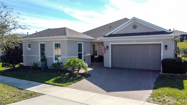 ranch-style home featuring a front lawn and a garage