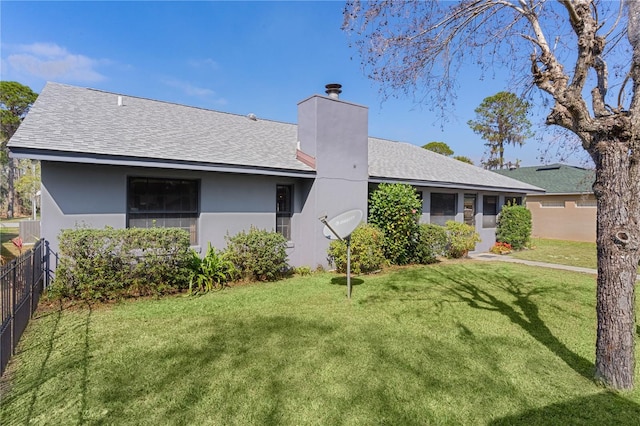 rear view of house featuring a lawn