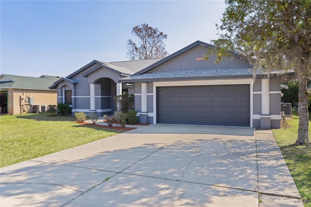 single story home with a garage and a front lawn