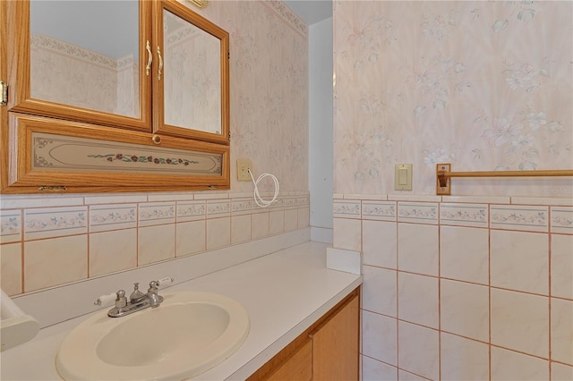 bathroom with vanity and tile walls