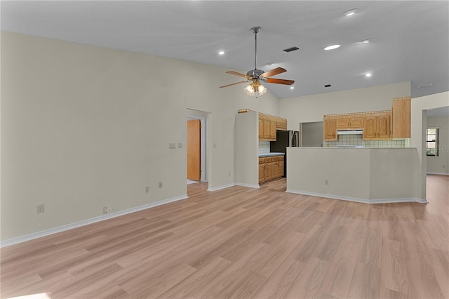 unfurnished living room with ceiling fan, high vaulted ceiling, and light hardwood / wood-style flooring