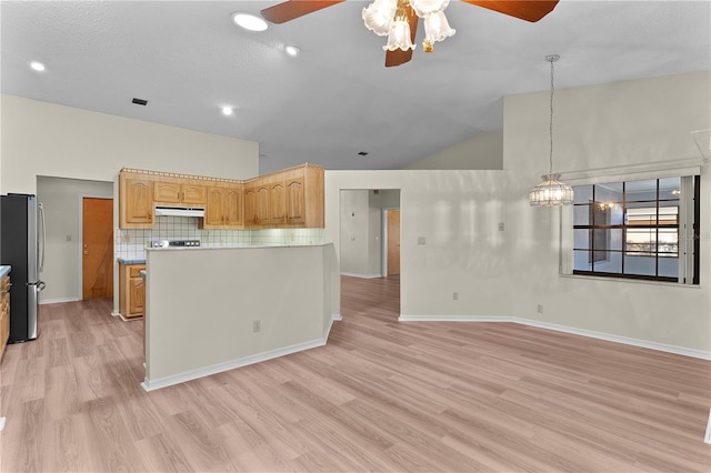 kitchen with lofted ceiling, stainless steel fridge, light brown cabinetry, and light hardwood / wood-style flooring