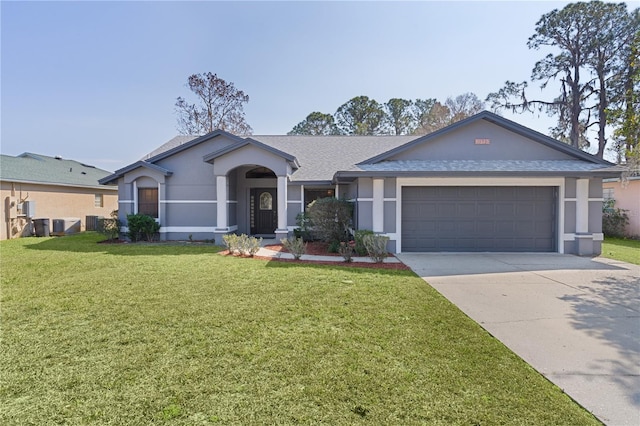 single story home featuring a garage and a front lawn