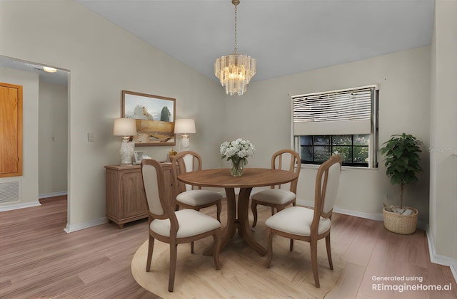 dining space featuring lofted ceiling, light hardwood / wood-style floors, and an inviting chandelier