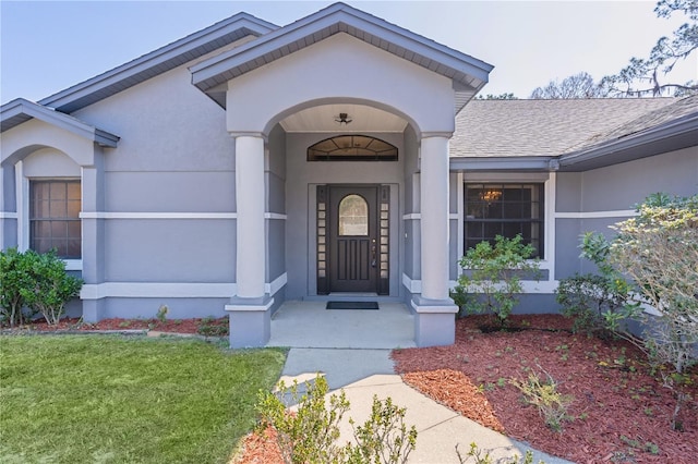 view of exterior entry featuring a yard