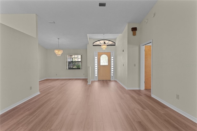 entryway with a notable chandelier and light wood-type flooring