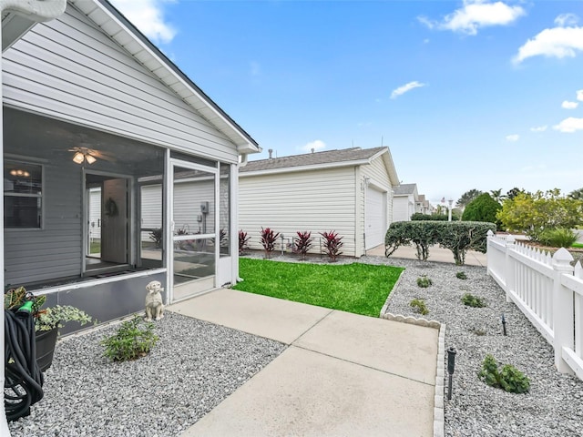 exterior space with a garage and a sunroom