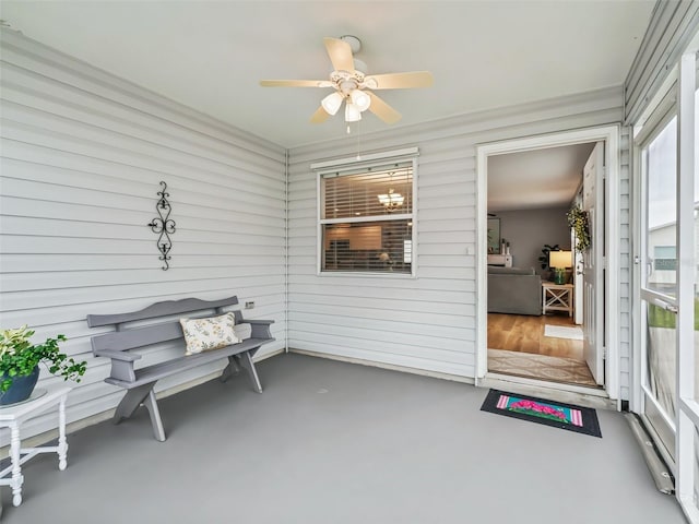 sunroom featuring ceiling fan