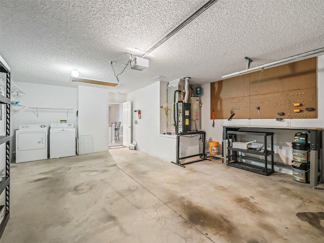 garage with washing machine and dryer, a garage door opener, heating unit, and a workshop area