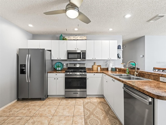 kitchen featuring stainless steel appliances, white cabinets, and sink