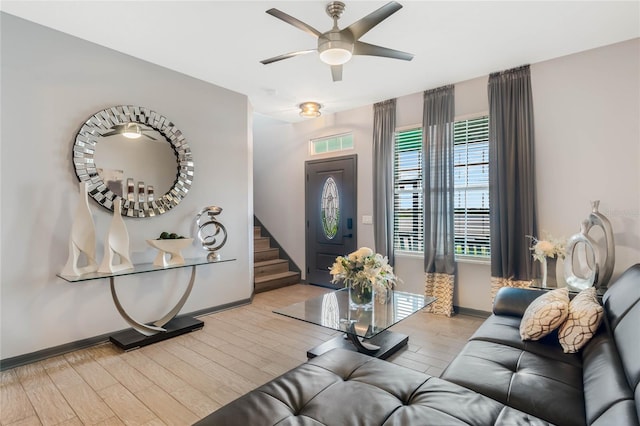 living room featuring ceiling fan and light hardwood / wood-style flooring