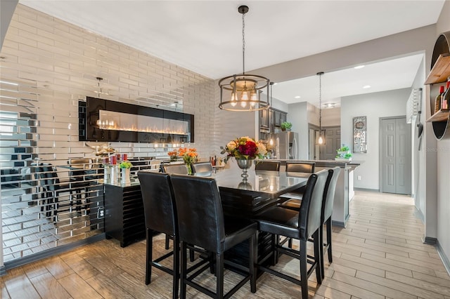 dining room featuring light hardwood / wood-style floors and an inviting chandelier