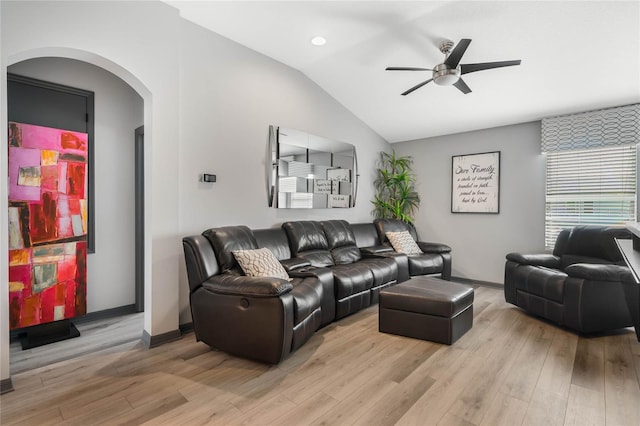 living room featuring ceiling fan, light hardwood / wood-style floors, and lofted ceiling