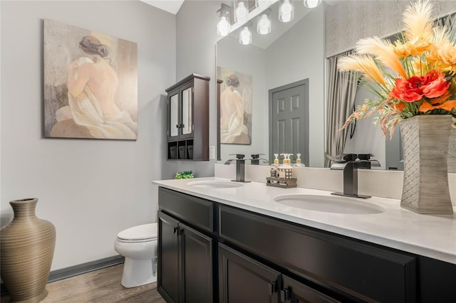 bathroom featuring hardwood / wood-style flooring, vanity, and toilet