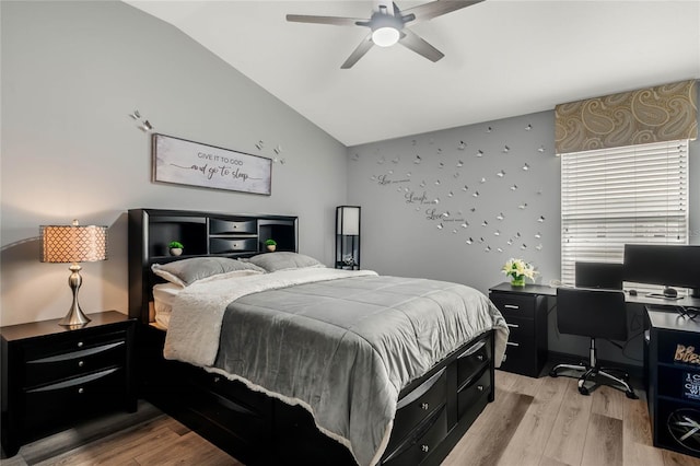 bedroom featuring light wood-type flooring, vaulted ceiling, and ceiling fan