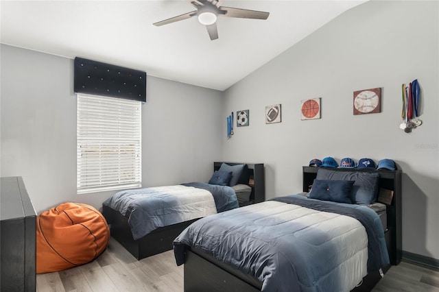 bedroom featuring light hardwood / wood-style flooring, ceiling fan, and lofted ceiling