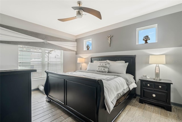 bedroom with multiple windows and ceiling fan