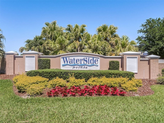 community sign featuring a lawn