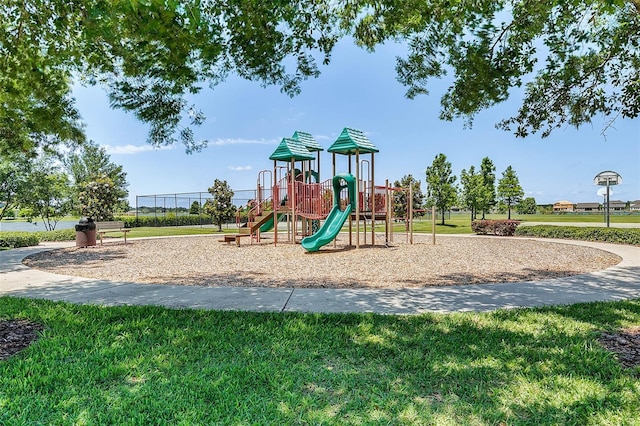 view of jungle gym featuring a lawn