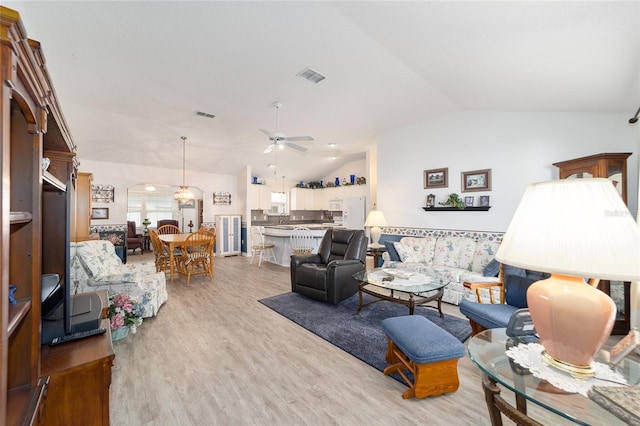 living room with wood-type flooring, ceiling fan, and lofted ceiling