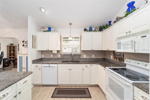 kitchen featuring white appliances, sink, decorative light fixtures, light hardwood / wood-style flooring, and white cabinets